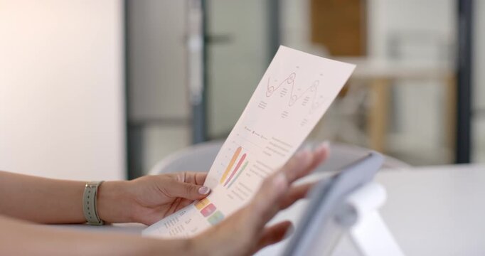 Hands with mint band are lifting and aligning report for inspection to tablet for chart comparison