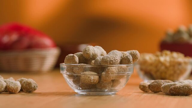 Peanuts in Salted Shell Man Cracking and Eating Salty Nuts as a Classic Bar Snack at Cafe