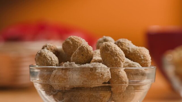 Peanuts in Salted Shell Man Cracking and Eating Salty Nuts as a Classic Bar Snack at Cafe