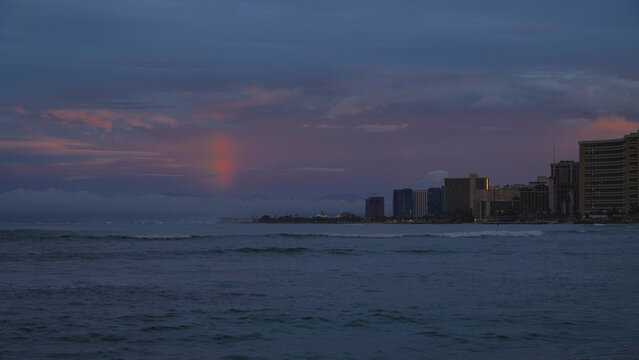 A rainbow over the ocean at dawn in Waikiki, Oahu, Hawaii