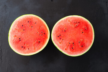 Ripe watermelon on black background © Banu Sevim