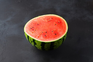 Ripe watermelon on black background © Banu Sevim