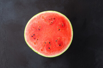 Ripe watermelon on black background © Banu Sevim