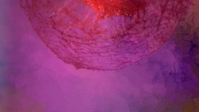 Mixing different colored alcohol inks in close-up view