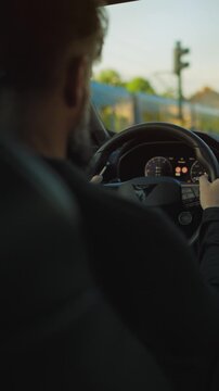 Man driving car through the streets of the city.