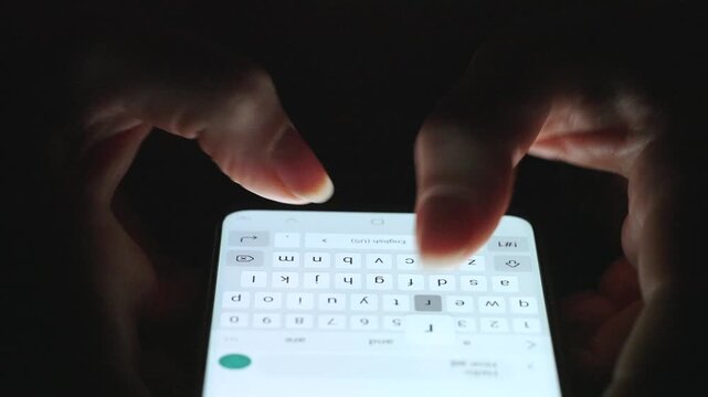 Female hands typing text on smartphone close-up.