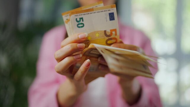 Woman counting euro bills, close-up