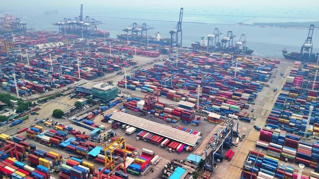 Indonesia - 18 July 2026: Aerial view of Port of Tanjung Priok with rows of colorful shipping containers and large cranes in the busy harbor.