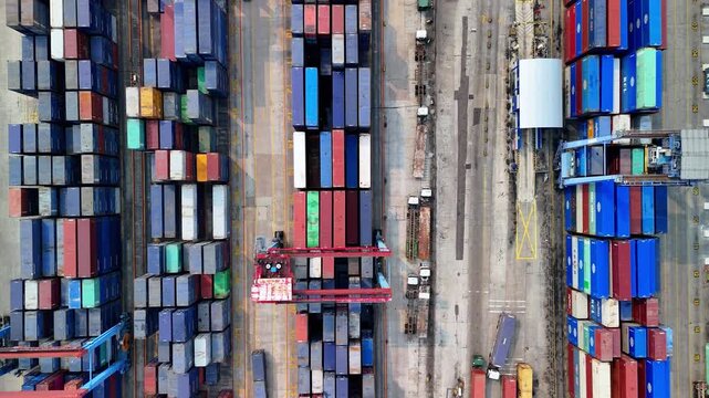 Indonesia - 18 July 2026: Aerial view of Port of Tanjung Priok with rows of colorful shipping containers, cranes, and trucks in a busy industrial port area.