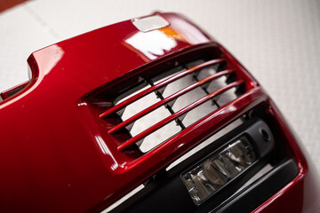 Naklejka premium Close up of a car bumper grille and air intake
