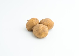 Fototapeta premium Small pile of fresh raw brown baby potatoes isolated on white background