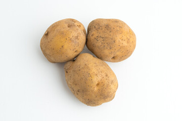 Fototapeta premium Small pile of fresh raw brown baby potatoes isolated on white background