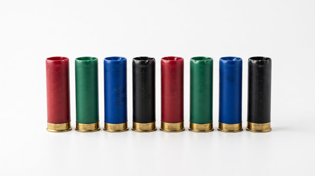 Row of colorful shotgun shells on white background for hunting and shooting sports