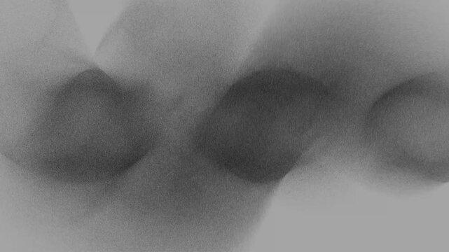 Abstract black and white blurred shapes with soft grain and flowing curves, creating a moody minimalist background for modern design, art, texture, or copy space use.