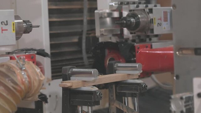 Automated routing process creates an interlocking joint for furniture manufacturing and wood assembly. CNC woodworking machine milling a precision edge profile on a wooden board.