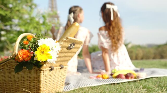 Picnic basket with flowers and bread near Eiffel Tower