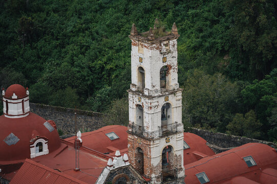 Historic bell tower of hacienda santa maria regla overlooking the green forest