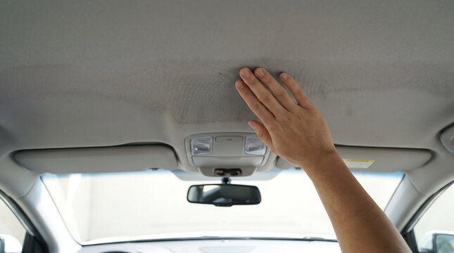 Hand touching car headliner fabric surface inside vehicle for quality inspection with car parts hand gesture automotive parts headliner material interior automotive