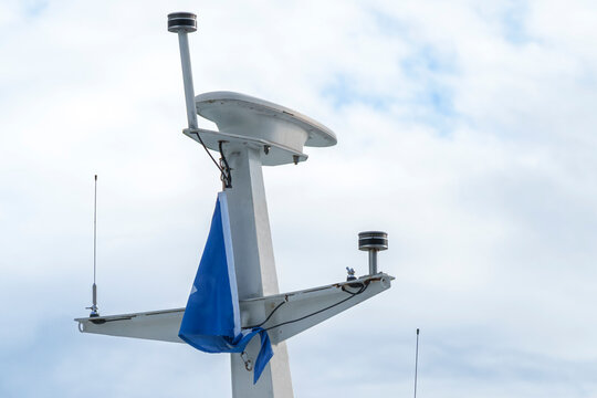 Ship mast with radar and antennas on a vessel, illustrating marine navigation technology and maritime communication systems.