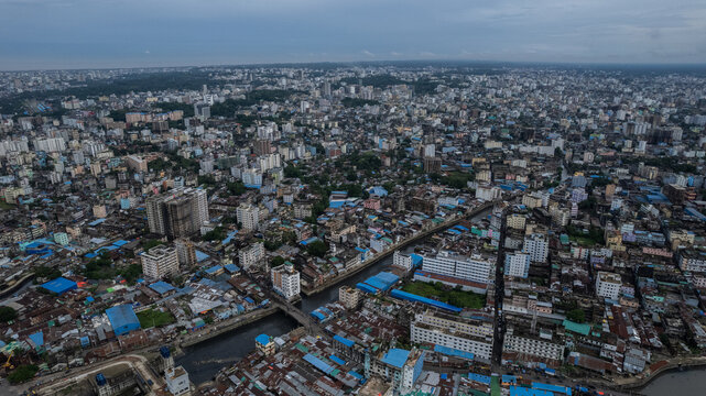 Aerial view of the dense urban landscape of Chittagong, featuring a network of canals, residential buildings, and commercial structures in Chittagong, Chittagong Division, Bangladesh.