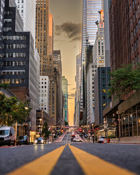 Manhattan Street at Golden Hour with Skyscrapers and Yellow Road Lines