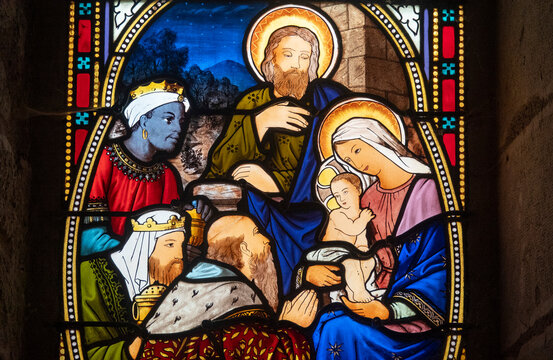 Stained glass (19th century) of Christmas Nativity Scene : Adoration of the Magi as they present gifts of gold, frankincense and myrrh to the Infant Jesus.