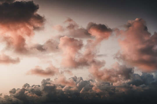 View of dramatic sunset clouds with soft pink and orange hues illuminating the sky over Vormsi, Laane County, Estonia.