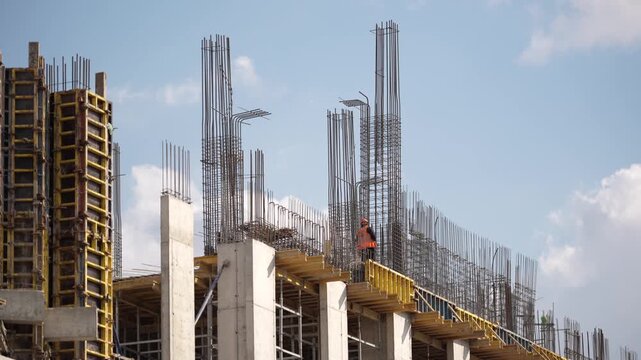 Construction site showing reinforced concrete structure, steel reinforcement and building progress during urban development project with modern engineering techniques