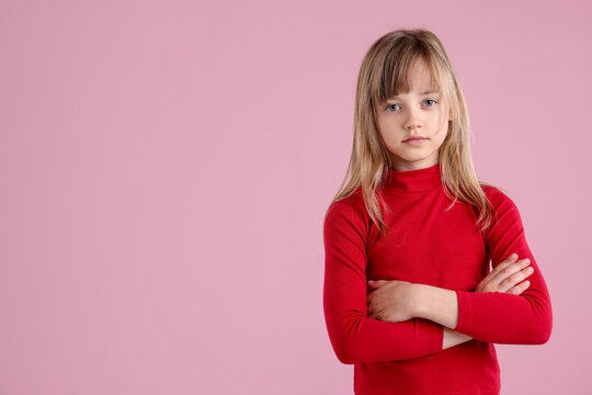 Portrait of cute little girl on pink background. Space for text