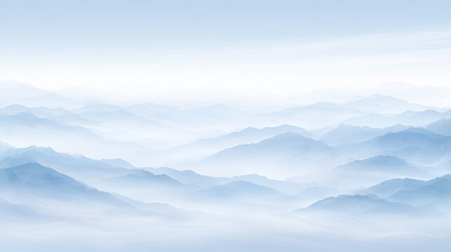 青空と霧に包まれた幾重もの山並みの風景
