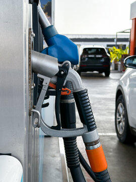 Fuel pump beside a white passenger vehicle. Closeup.
