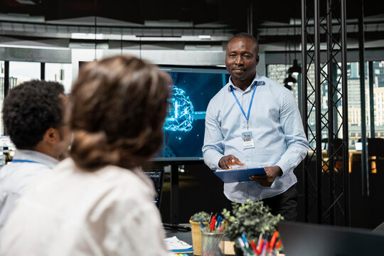 Company executive explains how AI can improve business productivity and presents implementation opportunities to investors during a startup meeting.