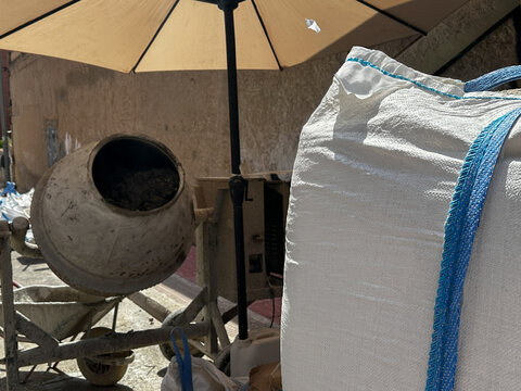 Portable cement mixer with dry building materials.