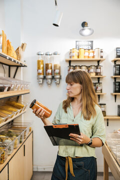 Woman checking product in natural healthy food store