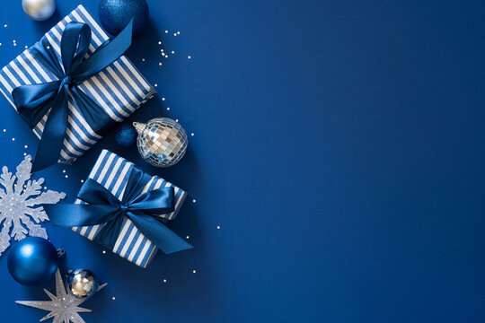 Merry Christmas blue gift flatlay with striped presents, ornaments and Happy New Year message space