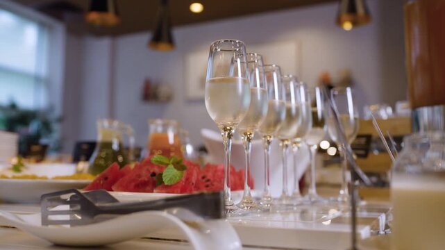 Buffet table with assorted drinks snacks and decorative ceramic fruits on marble surface