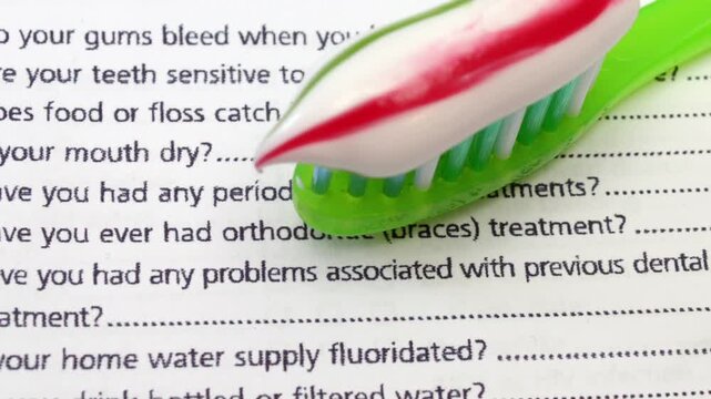 Dental Information Form with Toothbrush for Oral Health and Hygiene Concept