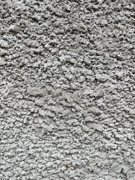 Full frame abstract texture of rough grey cement plaster wall background.