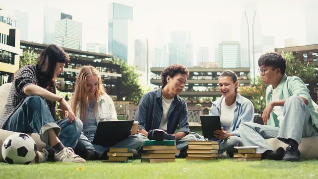 Portrait shows classmates in study session sitting on campus lawn for group study collaboration, reading notes from devices and books.