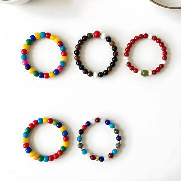 Five colorful beaded bracelets with various designs and materials, fashion accessories and jewelry, isolated on a white background