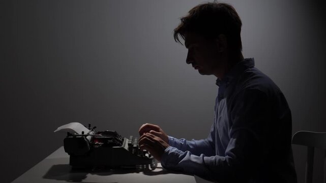 Man in silhouette sitting at a desk, focused on typing a story or novel on a vintage typewriter, representing creativity, inspiration, and the writing process