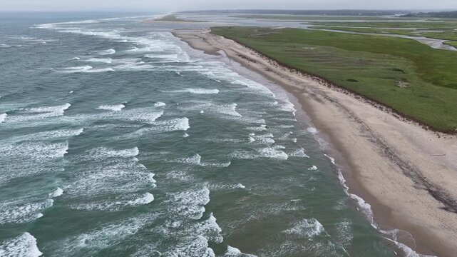 Waves from the Atlantic Ocean wash onto the scenic Cape Cod National Seashore. This beautiful part of the New England coast consists of over 40 miles of sandy beaches, marshes, ponds, and forest.