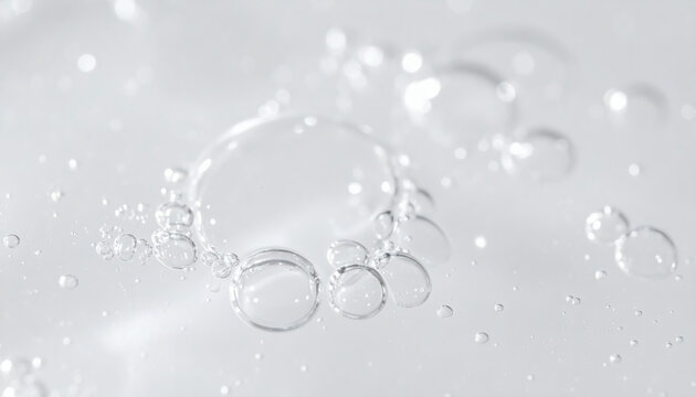 Water bubbles macro photography close up of transparent liquid surface with soft focus bokeh circles on a white background