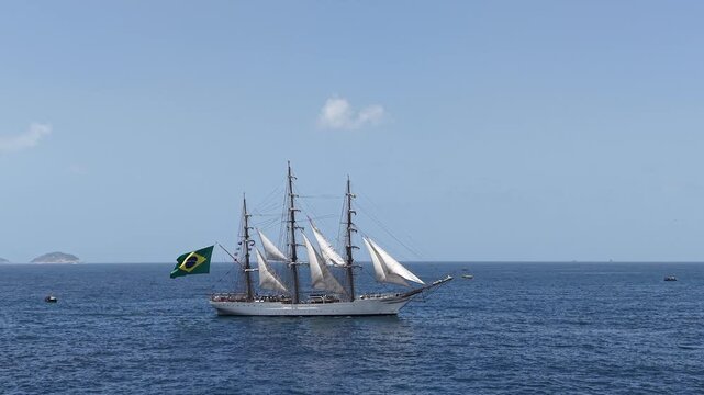 Aerial view of a three-masted sailing ship with sails sailing in the Atlantic Ocean. 