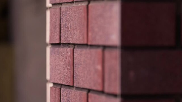 Red brick facade corner under construction close up