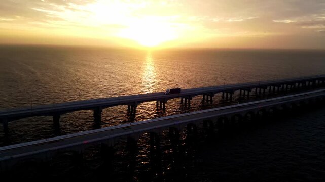 Aerial view of cars driving on Progreso Pier bridge at sunset
