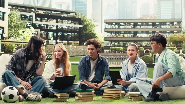 Woman student sits on campus grass near a tablet and discusses project notes with diverse classmates, supporting peer tutoring and collaborative study.