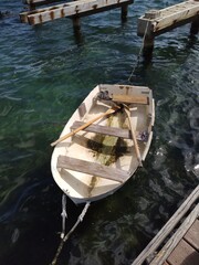 Old wooden rowboat tied to dock © HH Homestead