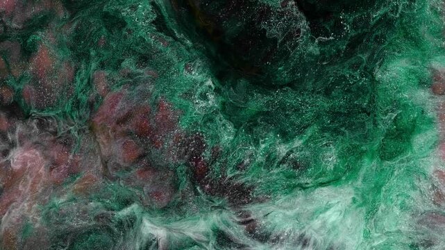 Mixing different colored alcohol inks in a close-up view