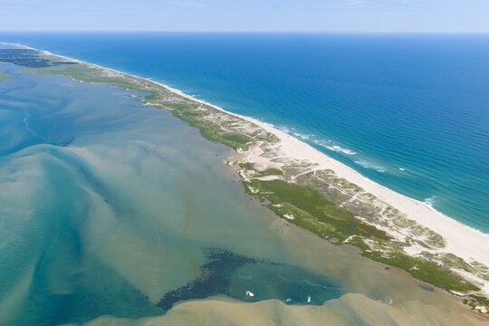 The Atlantic Ocean washes against the beautiful coast of Orleans on Cape Cod, Massachusetts. This outer Cape is a popular east coast vacation destination during summer months.